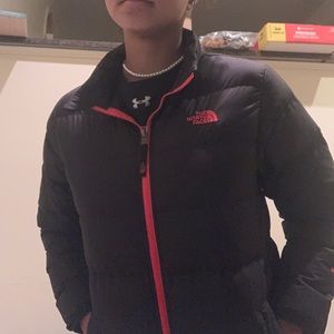 Red and blue boys north face puffer